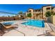 Community swimming pool and hot tub area with lounge chairs and clear blue skies at 10136 E Southern Ave # 3065, Mesa, AZ 85209