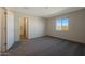 Bedroom features carpet flooring, a window providing natural light and an attached bathroom at 1071 W West Virginia Ave, Florence, AZ 85132