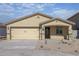 Attractive single-story home showcasing a two car garage and low maintenance front yard at 1071 W West Virginia Ave, Florence, AZ 85132