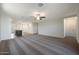 Spacious living room featuring neutral walls, carpet flooring, and an overhead ceiling fan at 1071 W West Virginia Ave, Florence, AZ 85132