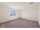 Spacious bedroom featuring neutral walls, carpet, and bright window at 1090 W West Virginia Ave, Florence, AZ 85132