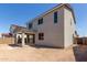Backyard with a covered patio extends from a stucco home, offering a shaded outdoor area at 11627 W Beck Ave, Youngtown, AZ 85363