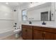 Inviting bathroom featuring double sinks, wood cabinets, quartz counters, a shower, and tile flooring at 11627 W Beck Ave, Youngtown, AZ 85363