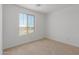 Bright bedroom featuring neutral walls, carpet floors, and a large window with mountain view at 11627 W Beck Ave, Youngtown, AZ 85363