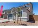 Charming two-story home featuring a gray exterior, stylish roof, and well-kept front yard at 11627 W Beck Ave, Youngtown, AZ 85363