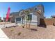 Attractive two-story home boasts a well-manicured yard, gray exterior, and inviting curb appeal at 11627 W Beck Ave, Youngtown, AZ 85363
