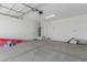 Spacious two-car garage with overhead door, white walls, and ample storage space at 11627 W Beck Ave, Youngtown, AZ 85363