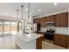 Modern kitchen featuring stainless steel appliances, a central island, and sliding glass doors to the backyard at 11627 W Beck Ave, Youngtown, AZ 85363