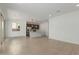 Open-concept living room and kitchen with modern tile floors and ample natural light at 11627 W Beck Ave, Youngtown, AZ 85363