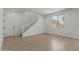 Bright living room featuring tiled flooring, a staircase, and a large window at 11627 W Beck Ave, Youngtown, AZ 85363