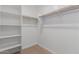 Well-organized walk-in closet with built-in shelving and rods for ample storage space at 11627 W Beck Ave, Youngtown, AZ 85363
