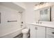 Bright bathroom features a shower over tub, a toilet, and a single sink vanity with storage at 12021 N Riviera Ct, Sun City, AZ 85351