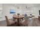 Stylish dining room with seating for four, a ceiling fan, and an open-concept layout at 12021 N Riviera Ct, Sun City, AZ 85351