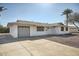 Beautiful single-story home with a driveway, a two-car garage, and desert landscaping at 12021 N Riviera Ct, Sun City, AZ 85351