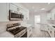 Modern kitchen featuring stainless steel appliances, white cabinets, and a bright, clean aesthetic at 12021 N Riviera Ct, Sun City, AZ 85351