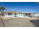 View of the rear exterior with a covered patio and desert landscaping at 12021 N Riviera Ct, Sun City, AZ 85351