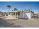 Rear exterior with a covered patio, desert landscaping, and painted exterior at 12021 N Riviera Ct, Sun City, AZ 85351