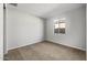 A bedroom with neutral carpet, light walls, and a window providing natural light at 13548 W Copperleaf Ln, Peoria, AZ 85383
