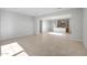Open-concept living space with tile floors, abundant natural light, and seamless flow to the kitchen at 13548 W Copperleaf Ln, Peoria, AZ 85383