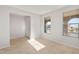 Bright and airy living room featuring tile flooring and ample natural light from large windows at 13548 W Copperleaf Ln, Peoria, AZ 85383