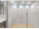 Walk-in shower featuring modern design, white tile, glass surround, overhead shower, and integrated bench at 13548 W Copperleaf Ln, Peoria, AZ 85383
