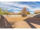 Large backyard with a brick paver patio area, desert landscaping, and a block wall surrounding the yard at 1380 W Angus Rd, San Tan Valley, AZ 85143
