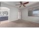 Bright bedroom with a ceiling fan, window, and attached bathroom for a relaxing retreat at 1380 W Angus Rd, San Tan Valley, AZ 85143
