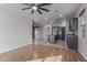 Spacious open-concept with wood floors, modern lighting, and adjoined kitchen at 1380 W Angus Rd, San Tan Valley, AZ 85143