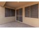 Relaxing covered patio with brick flooring and access to the home through multiple glass-screened doors and windows at 1380 W Angus Rd, San Tan Valley, AZ 85143