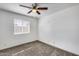 This bedroom features neutral carpet, a ceiling fan, and a window for natural light at 14644 N Yerba Buena Way # C, Fountain Hills, AZ 85268