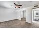 Bedroom with neutral carpet, ceiling fan, and sliding mirrored closet doors with bathroom access at 14644 N Yerba Buena Way # C, Fountain Hills, AZ 85268