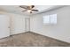Empty bedroom with carpet, ceiling fan, window letting in natural light, and a white door against a white wall at 14644 N Yerba Buena Way # C, Fountain Hills, AZ 85268