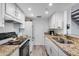 Galley kitchen with stainless steel appliances, white cabinets and granite countertops at 14644 N Yerba Buena Way # C, Fountain Hills, AZ 85268