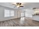 Bright living room with gray floors, ceiling fan, and direct access to the outdoor patio at 14644 N Yerba Buena Way # C, Fountain Hills, AZ 85268