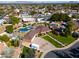 Stunning aerial view of a home with a large lot, mature trees, and a charming neighborhood at 1520 E Elmwood Cir, Mesa, AZ 85203