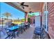 Spacious outdoor back patio with an outside kitchen area, a large dining table and ceiling fans at 1520 E Elmwood Cir, Mesa, AZ 85203