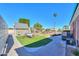 The backyard features a charming playhouse, swing set, and well-maintained landscaping at 1520 E Elmwood Cir, Mesa, AZ 85203
