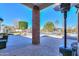 Covered backyard patio offers views of the pool, landscaping, and a charming playhouse at 1520 E Elmwood Cir, Mesa, AZ 85203