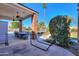 The backyard patio includes an outdoor dining area, brick columns, and a landscaped yard with pool at 1520 E Elmwood Cir, Mesa, AZ 85203
