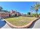 Expansive backyard featuring lush lawns, mature trees, and a decorative brick border at 1520 E Elmwood Cir, Mesa, AZ 85203