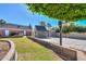 Backyard view showing lush green grass and landscaping at 1520 E Elmwood Cir, Mesa, AZ 85203