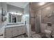Bright bathroom with a tile shower, marble countertop, and white cabinets at 1520 E Elmwood Cir, Mesa, AZ 85203