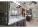 Bathroom with granite counter tops and dual sinks with dark wood cabinetry at 1520 E Elmwood Cir, Mesa, AZ 85203