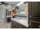 Bathroom with granite counter tops and dual sinks with dark wood cabinetry at 1520 E Elmwood Cir, Mesa, AZ 85203