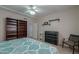Comfortable bedroom with a bookshelf, dresser, and a ceiling fan at 1520 E Elmwood Cir, Mesa, AZ 85203
