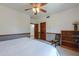 Spacious bedroom with carpeted floor, ceiling fan, a chair and a bookshelf at 1520 E Elmwood Cir, Mesa, AZ 85203