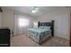 Cozy bedroom with a queen-size bed, soft carpet, decorative pillows, and bright natural light at 1520 E Elmwood Cir, Mesa, AZ 85203