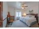 Comfortable bedroom featuring a decorative ceiling fan, neutral carpeting, and a wooden bed frame at 1520 E Elmwood Cir, Mesa, AZ 85203