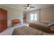 Bright bedroom showing two beds, a window with curtains, and a bench at 1520 E Elmwood Cir, Mesa, AZ 85203