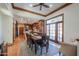 Elegant dining room featuring a large wooden table, stained glass window, and hardwood floors at 1520 E Elmwood Cir, Mesa, AZ 85203